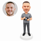 custom bobblehead figure man in a gray V-neck T-shirt holding a camera with both hands