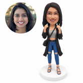 custom bobblehead figure woman in a fringed long coat and cropped jeans with both hands raised