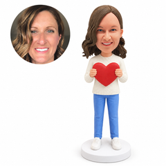 custom bobblehead figure woman in a knit sweater and jeans holding a heart