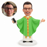 custom bobblehead figure priest in a wide chasuble with arms outstretched holding a Bible