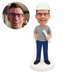 custom bobblehead figure engineer in a T-shirt holding a rolled blueprint with a hand in his pocket