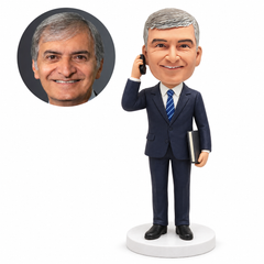 custom bobblehead figure businessman in a suit making a phone call with a book under his arm