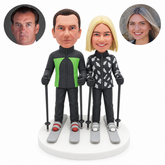 custom bobblehead figures skiing couple in zip front jackets each holding two poles