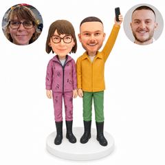 custom bobblehead figures winter couple with a man holding a phone overhead