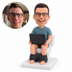 custom bobblehead figure man sitting on a toilet holding an open laptop