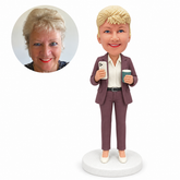 custom bobblehead figure businesswoman in a trouser suit holding a phone and a drink