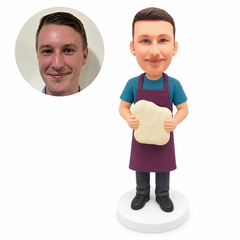 custom bobblehead figure man in an apron holding a large piece of dough