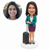 custom bobblehead figure female flight attendant resting both hands on a suitcase handle