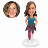 custom bobblehead figure woman in sports leggings with a jacket tied at her waist and both thumbs raised
