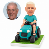 custom bobblehead figure man in a T-shirt and shorts driving a ride-on lawn mower