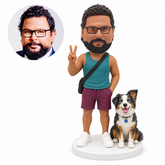 custom bobblehead figure man in a tank top and shorts making a peace sign beside a dog