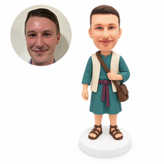custom bobblehead figure man in a tunic holding the strap of a satchel