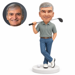 custom bobblehead figure male golfer with club on shoulder hand in pocket and crossed ankles; original Bobblefigurine sculpted clay head and matching human portrait.