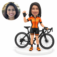 custom bobblehead figure female cyclist waving beside a road bicycle