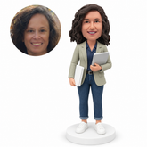 custom bobblehead figure female software engineer carrying a tablet and a closed laptop