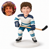 custom bobblehead figure male hockey player holding a stick across his waist with bent knees