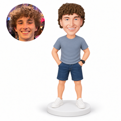 custom bobblehead figure man in a short-sleeve t-shirt and denim shorts with both hands in his pockets – original polymer-clay sculpture head and matching photo