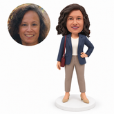 custom bobblehead figure woman in a blazer and ankle trousers with a shoulder bag and one hand on her hip