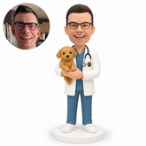 custom bobblehead figure male veterinarian cradling an upright dog against his chest