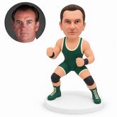 custom bobblehead figure male wrestler in a wide crouching guard with one fist at chest height and one fist at his abdomen