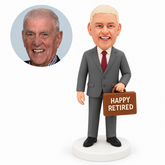 custom bobblehead figure retired businessman holding a horizontal briefcase by its handle in front of one thigh with his other arm down