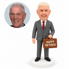 custom bobblehead figure retired businessman holding a horizontal briefcase by its handle in front of one thigh with his other arm down