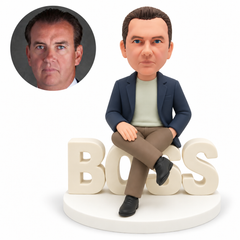 custom bobblehead figure man seated on BOSS letters with crossed legs and one hand in his pocket MGA-AC1201