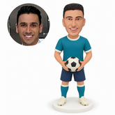 custom bobblehead figure male soccer player holding a ball low at his waist with both bare hands