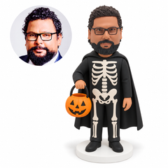 custom bobblehead figure man in a skeleton costume and cape holding a pumpkin bucket
