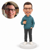 custom bobblehead figure man in a hooded pullover holding a takeaway coffee cup with his other hand in a trouser pocket MGA-AC1232