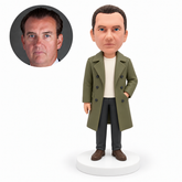 custom bobblehead figure man in a trench coat with one hand in an outer coat pocket MGA-AC1260