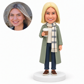 custom bobblehead figure woman in a long coat and scarf holding a takeaway coffee cup MGA-AC1264