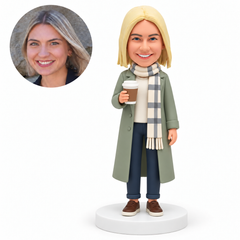 custom bobblehead figure woman in a long coat and scarf holding a takeaway coffee cup MGA-AC1264