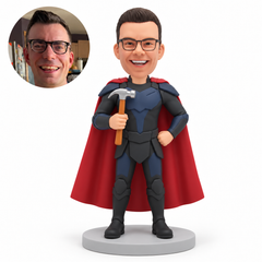custom bobblehead figure male hero in armor and a cape holding an upright hammer with one hand on his hip MGA-AC1283