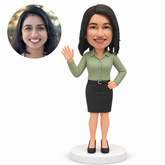 MGA-AC1287 custom bobblehead figure woman in a blouse and pencil skirt waving with one hand on her hip