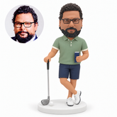 MGA-AC1294 custom bobblehead figure male golfer resting one hand on a club while holding a drink with crossed ankles