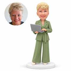 MGA-AC1306 custom bobblehead figure businesswoman in a belted trouser suit typing on an open laptop