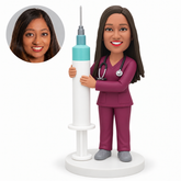 Custom bobblehead figure female medical worker holding a floor-standing giant syringe with both hands