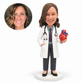 custom bobblehead figure female doctor holding an anatomical heart model