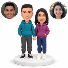 custom bobblehead figures couple in hoodies holding hands with both outer hands in pockets