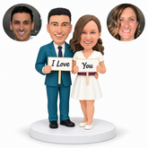 custom bobblehead figures couple holding two separate I Love and You signs with the man keeping an arm around the womans waist - MGA-AC1425