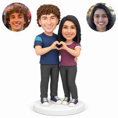 custom bobblehead figures couple in short sleeve t shirts forming one heart together with their outer hands while embracing at the waist - existing original polymer clay head and matching real photo