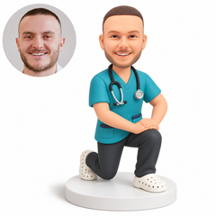 custom bobblehead figure male doctor in scrubs kneeling on one knee with both hands resting on his raised knee - original own-site polymer clay head and matched photo