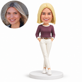 custom bobblehead figure woman in a crew neck pullover and full trousers with both hands in pockets and crossed ankles