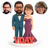 custom bobblehead figures wedding couple embracing at the waist with their outer arms lowered beside VDAY letters