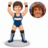 custom bobblehead figure male wrestler raising both fists overhead in a victory pose with original clay head and matching photograph