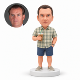 custom bobblehead figure man in a short-sleeve shirt and shorts holding an iced drink with a straw