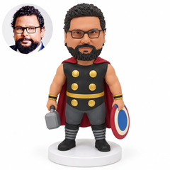 custom bobblehead figure stocky male hero holding a hammer and round shield low at his sides