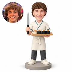 Sushi cook holding an upright knife and displaying four sushi pieces on a board, custom clay figure