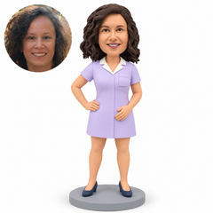 custom bobblehead figure female nurse with one hand on her hip and her other palm resting on her lower abdomen